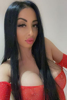 Very busty girl with black hair taking a selfie